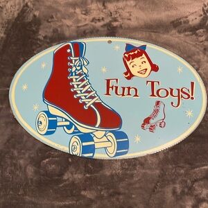 Porcelain Enamel Metal Sign that says fun toys pictures of roller skatesVintage